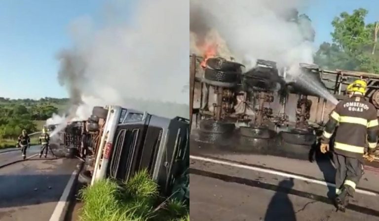 CAMINHÃO DE CACHAÇA TOMBA NA GO 080, EM NERÓPOLIS E BOMBEIROS COMBATEM INCÊNDIO